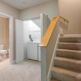 Bathroom options with thoughtful details a bathroom and laundry closet next to staircase