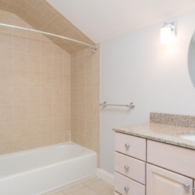 Spacious bathrooms with everything you need shower/tub combo in brightly lit bathroom