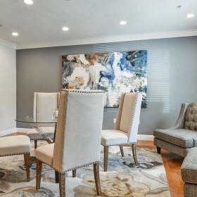 Beautiful living spaces with natural lighting living room with glass top table  and cushioned chairs